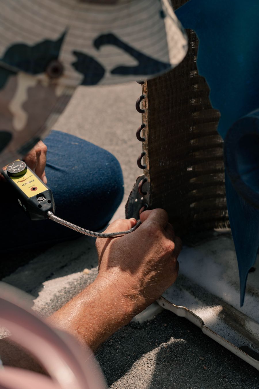 A technician mid-service on an AC unit